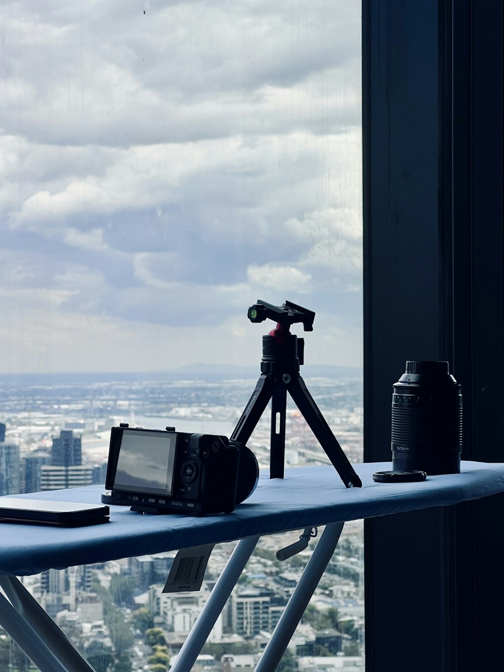 a table with a camera and a tripod on top of it