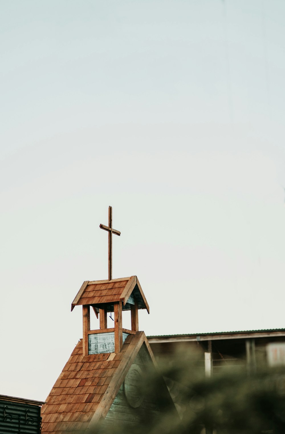 a church steeple with a cross on top of it