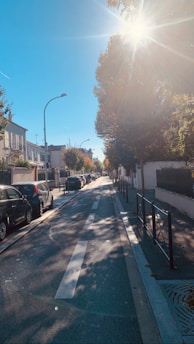 A calm and supportive driving lesson taking place on a quiet suburban street.
