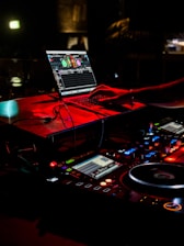 a dj mixing music in front of a laptop
