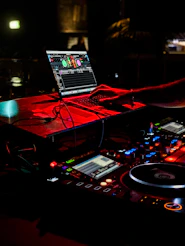a dj mixing music in front of a laptop