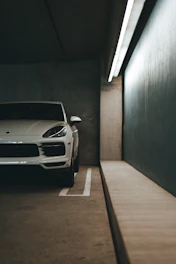 a white sports car parked in a parking garage