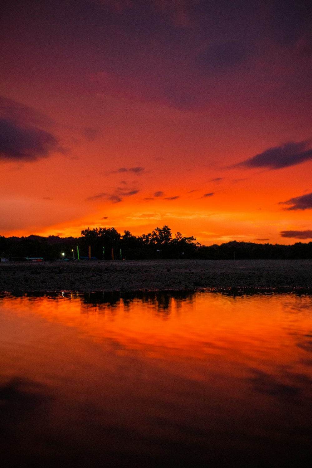 a beautiful sunset reflecting off the water of a lake