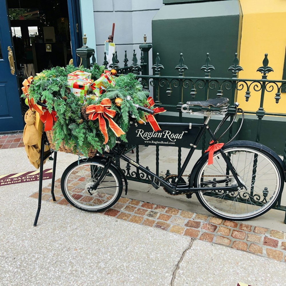 a bicycle with a basket full of christmas decorations