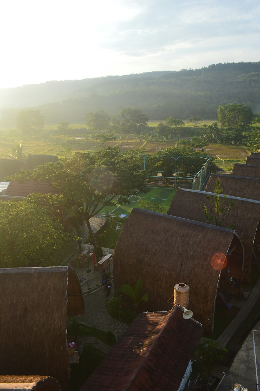 an aerial view of a village with thatched roofs