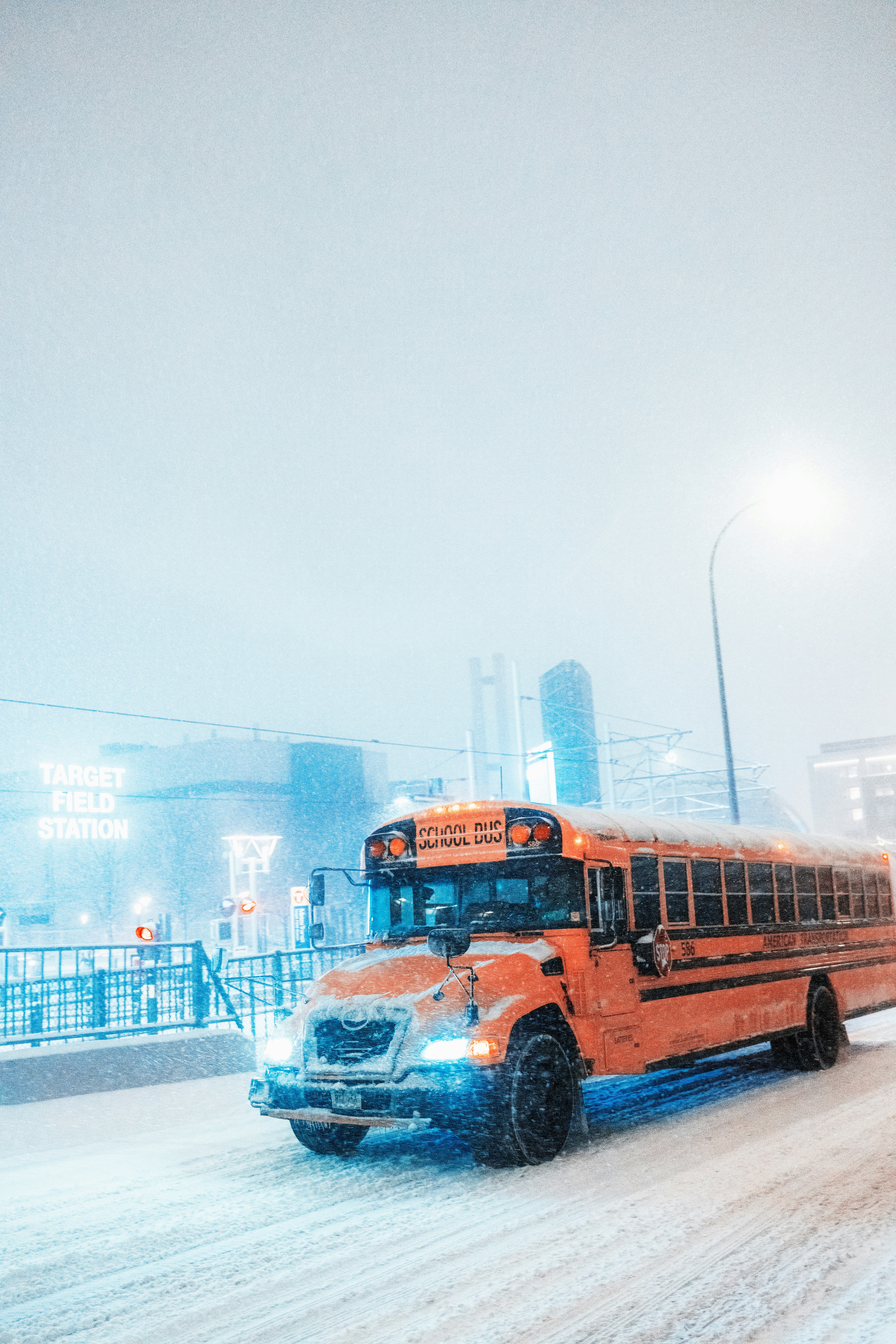 a school bus driving down a snowy street