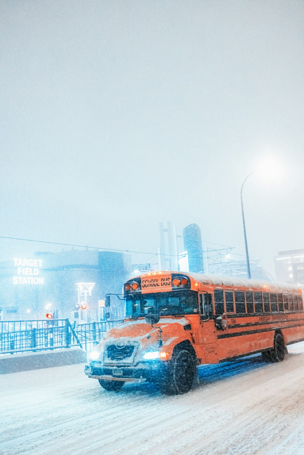 a school bus driving down a snowy street