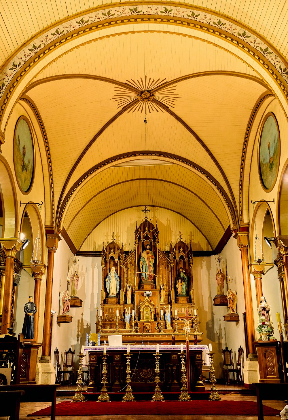 a church with a vaulted ceiling and wooden pews