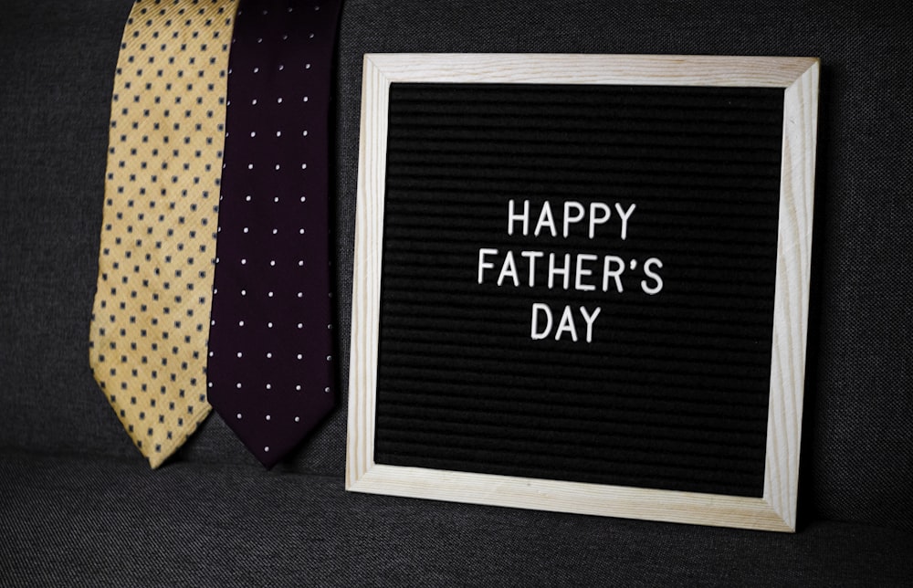 a father's day sign next to two ties