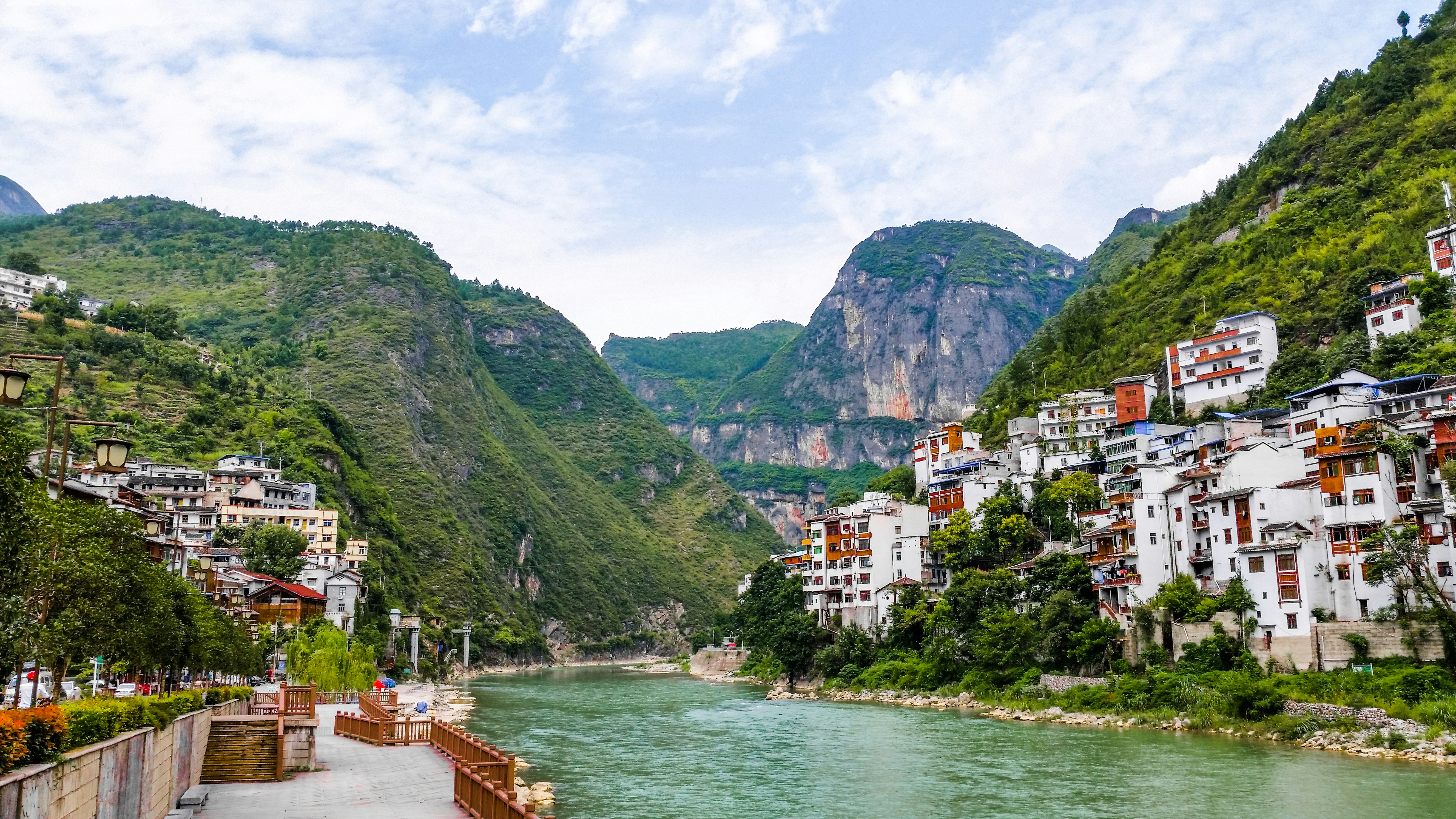 a river running through a lush green valley