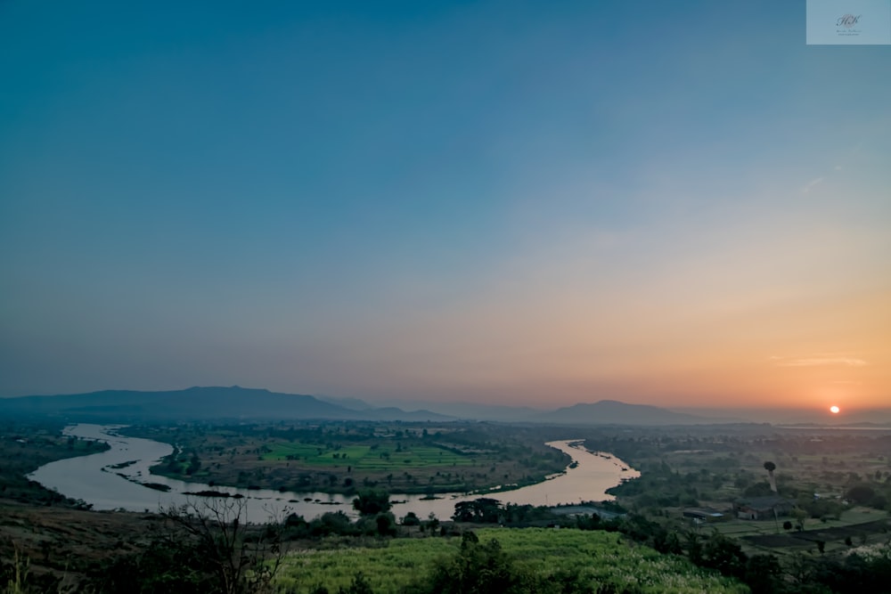 a river running through a lush green countryside