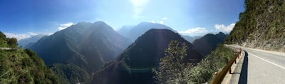 Scenic view of a winding road through Canadian mountains under a clear blue sky.