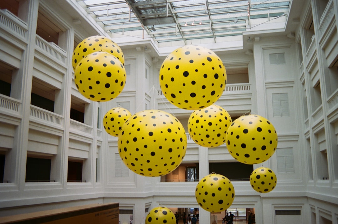 a group of yellow and black polka dots hanging from a ceiling,