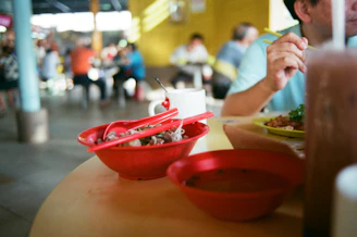 a man sitting at a table with a plate of food