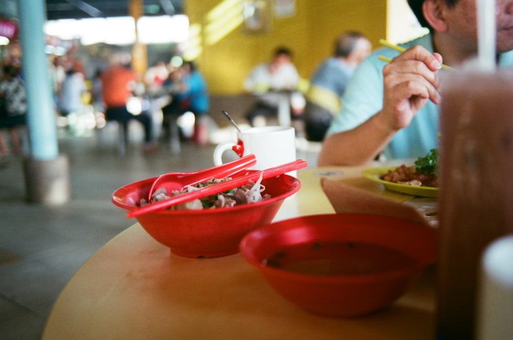 a man sitting at a table with a plate of food