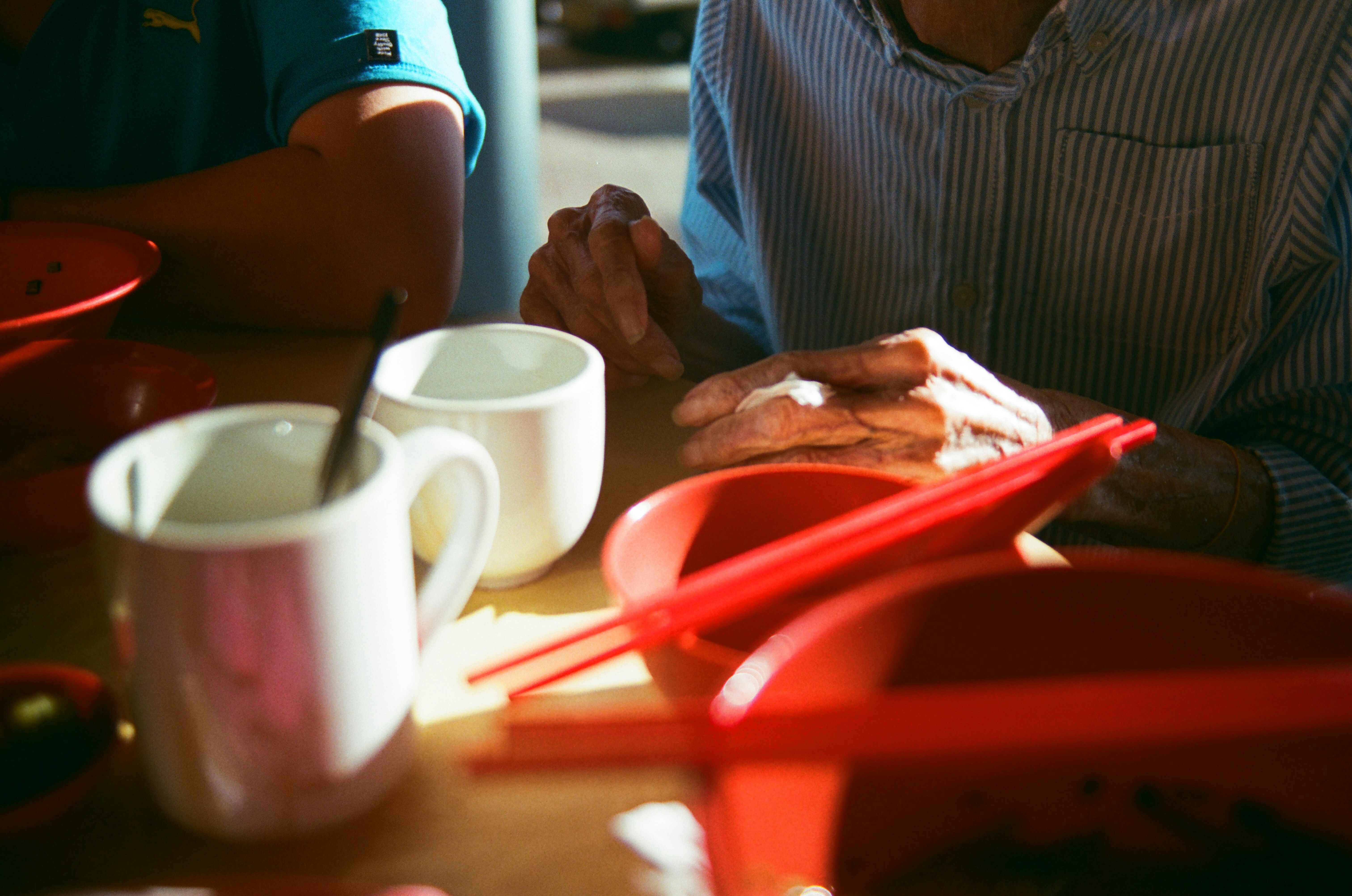 a man sitting at a table with a plate of food