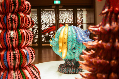 A vibrant installation from a recent artist-led exhibition curated by Sam Dicker, featuring bold colors and dynamic shapes.