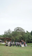 A respectful meeting between lawyers and native community leaders in a natural setting.