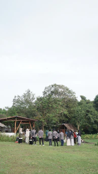 A respectful meeting between lawyers and native community leaders in a natural setting.