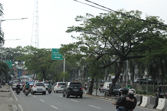 A busy city street with commuters using various modes of transportation.