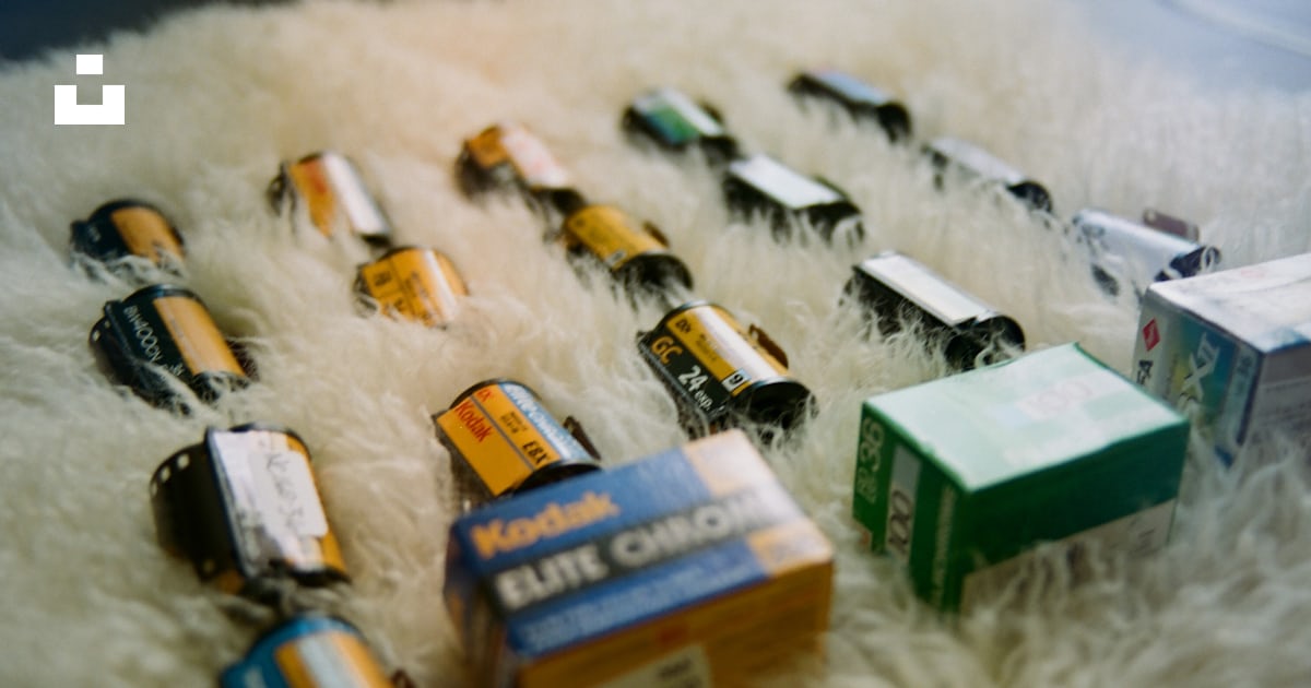 A bunch of different types of batteries on a white rug photo – Free ...