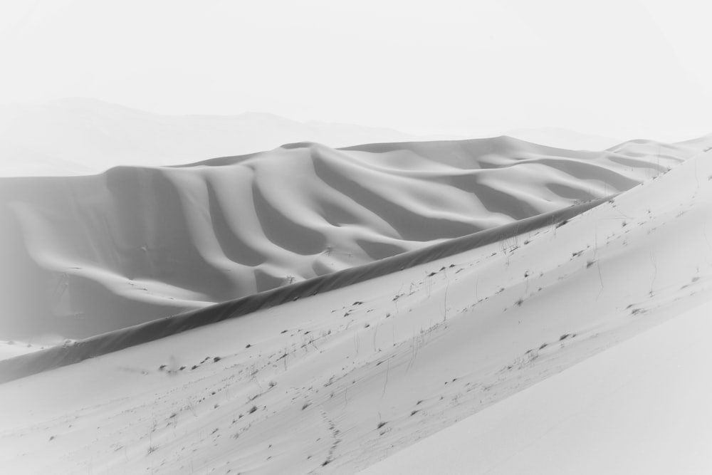 a black and white photo of a sand dune