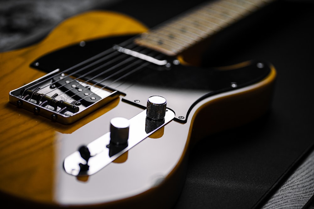 a close up of an electric guitar on a table