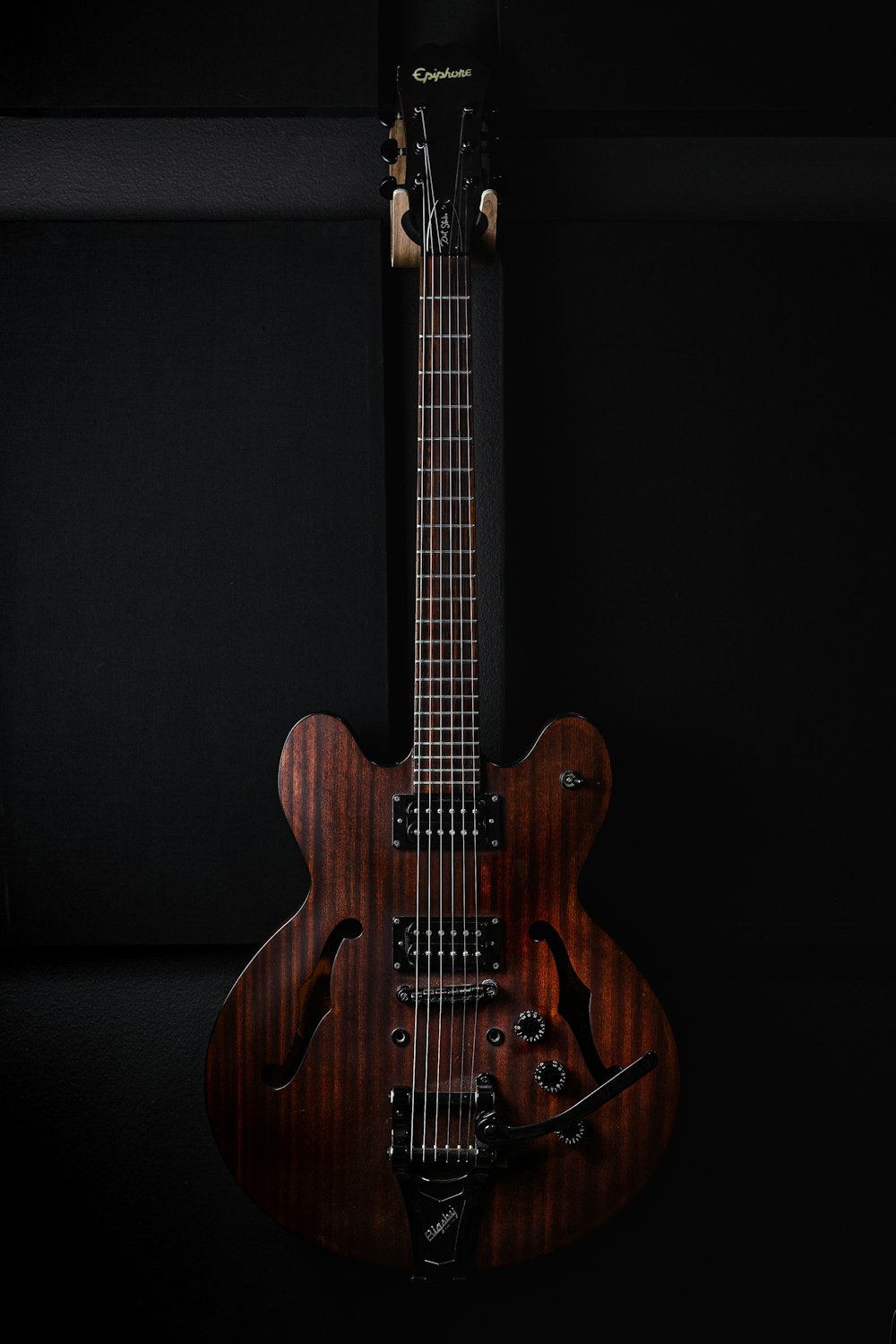 a close up of a guitar on a black background