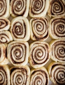 a close up of a plate of cinnamon rolls