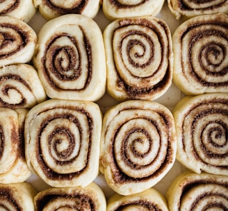 a close up of a plate of cinnamon rolls