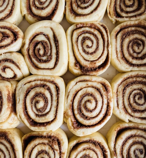 a close up of a plate of cinnamon rolls