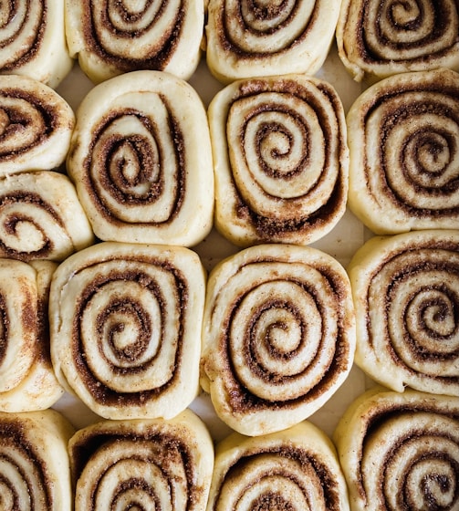 a close up of a plate of cinnamon rolls