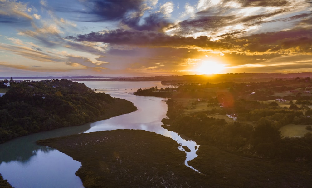 the sun is setting over a body of water