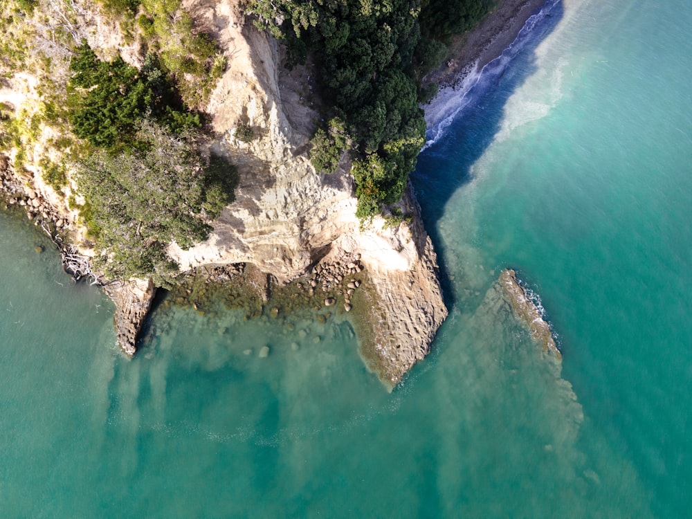 an aerial view of a body of water next to a cliff