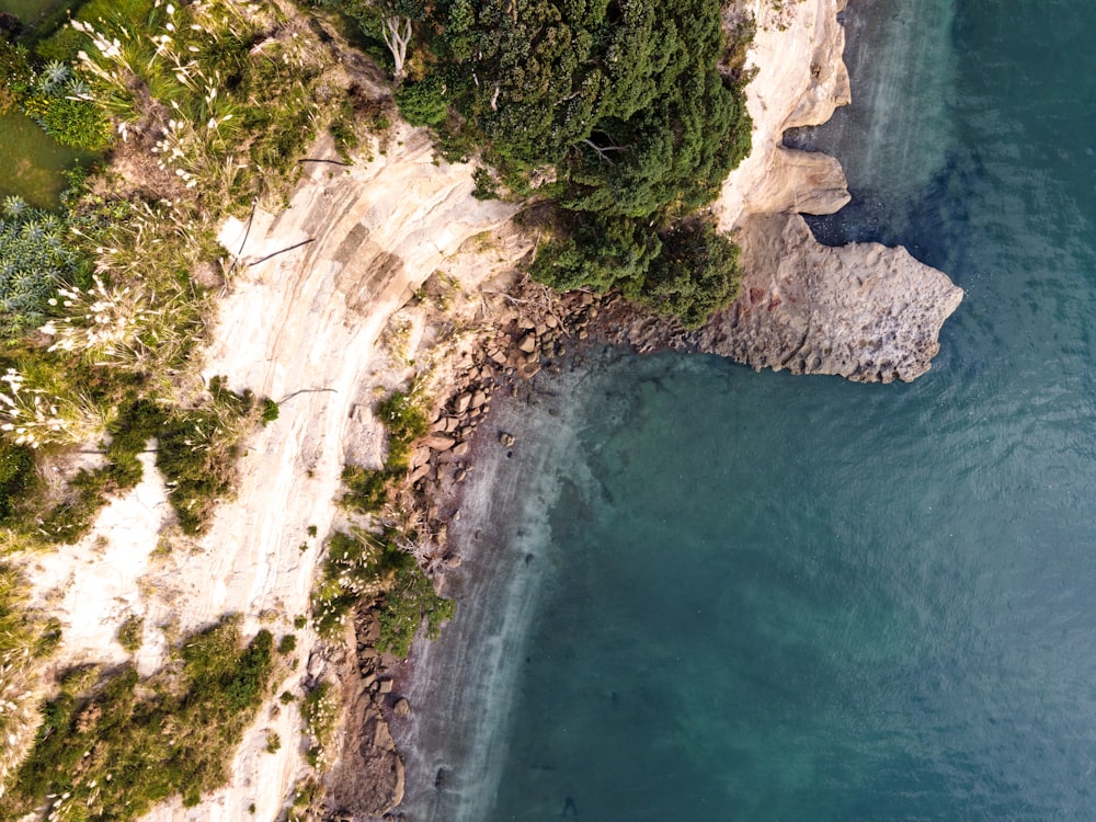 a bird's eye view of a beach and a cliff