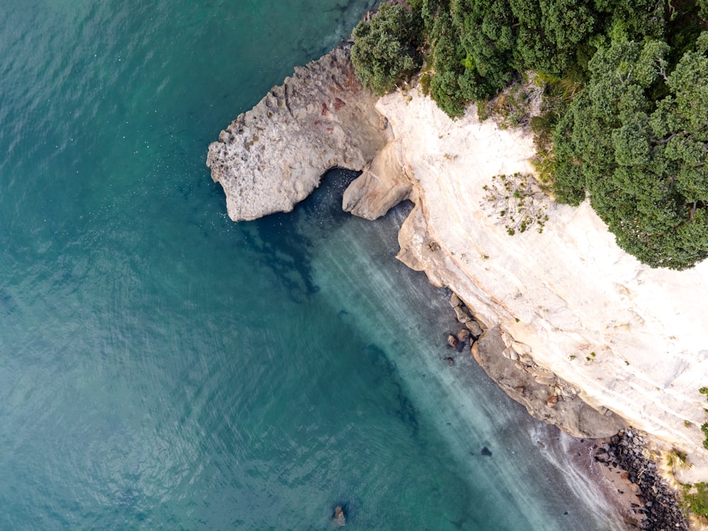 an aerial view of a body of water near a cliff