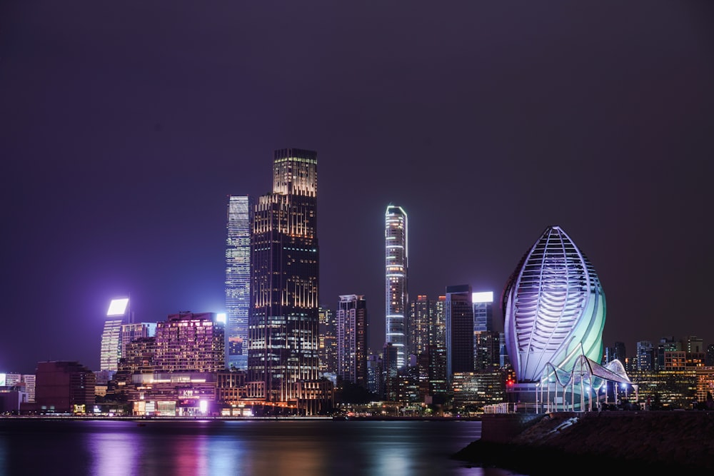 a city at night with lights reflecting in the water