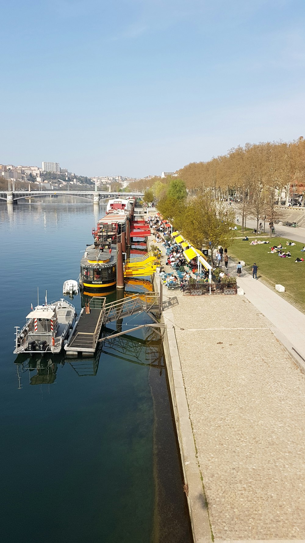 a group of boats parked next to a pier