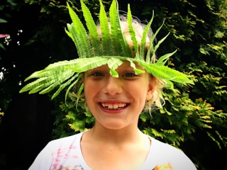 A cheerful child wearing a handmade headband.