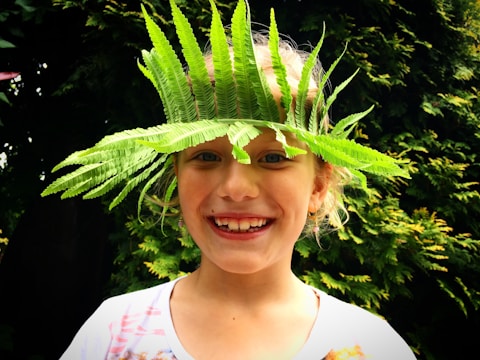 A cheerful child wearing a handmade headband.