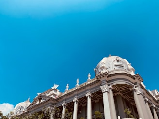 a large building with columns and statues on top of it