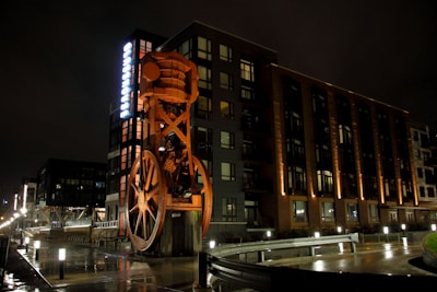 Night view of an illuminated industrial structure highlighting its geometric design.