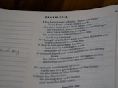 A close-up view of a page from a book with text from Psalm 27:8-14. The text is printed in a neat font on a slightly off-white page. There are sections of dotted lines on the left side and handwritten notes visible on the margin. The text references themes of seeking, guidance, and faith.