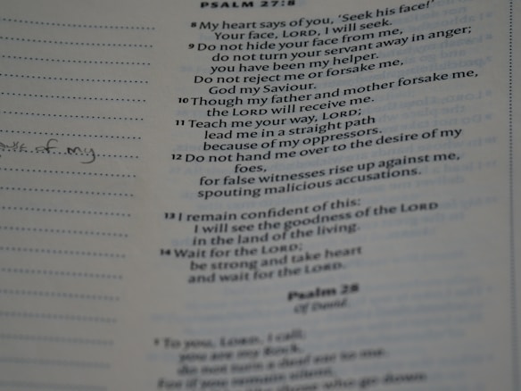 A close-up view of a printed page from a book, showing a text passage. The text is in a structured format resembling a religious scripture or hymn. Notes are handwritten in the margins with lined spaces available for writing.