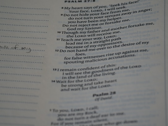 A close-up view of a printed page from a book, showing a text passage. The text is in a structured format resembling a religious scripture or hymn. Notes are handwritten in the margins with lined spaces available for writing.