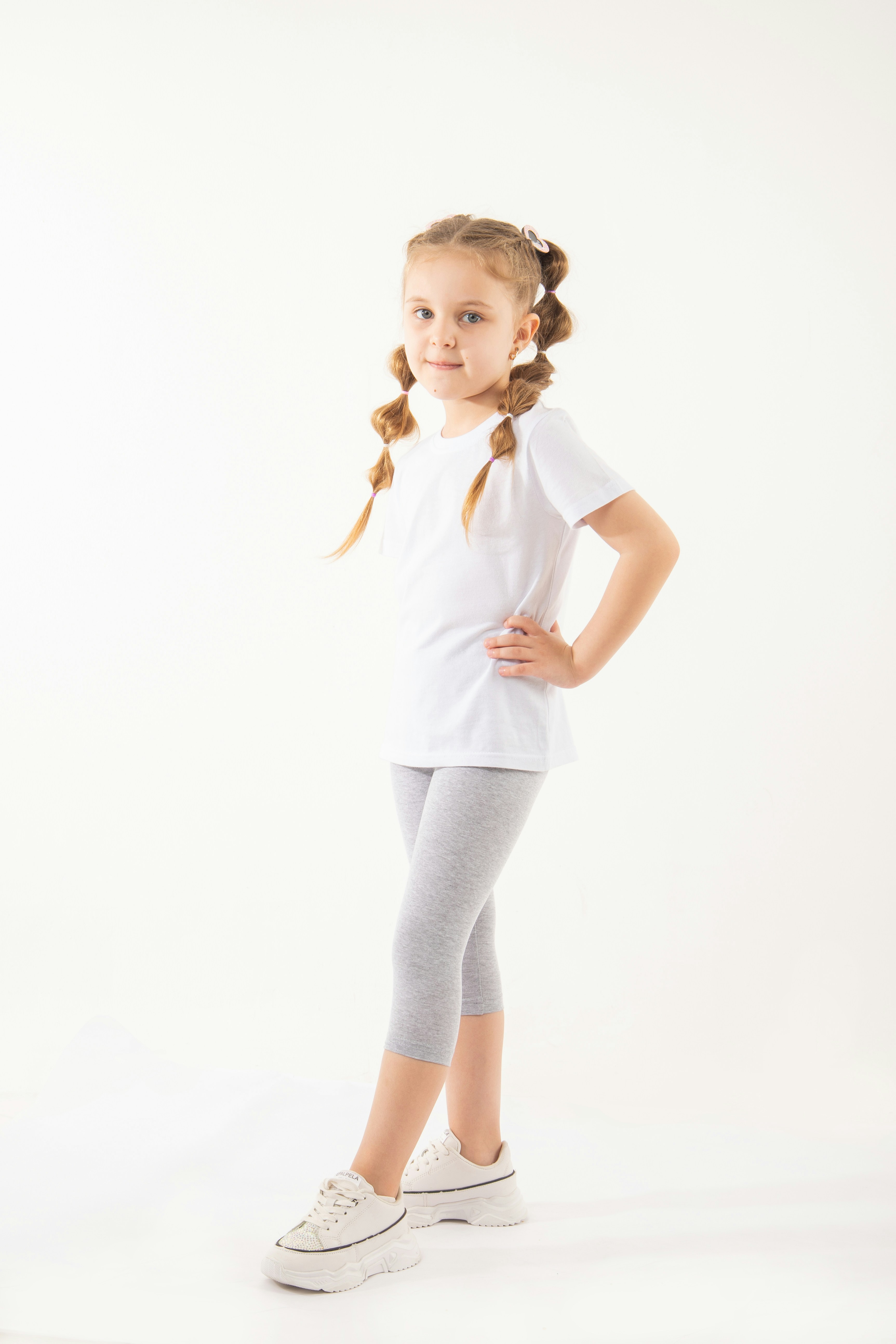 A little girl is standing with her hands on her hips photo – Free Baby ...