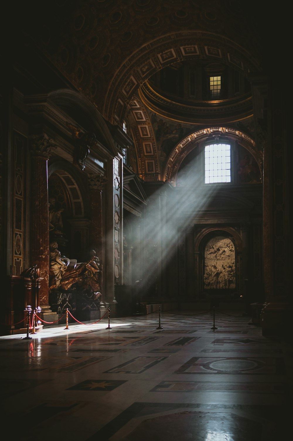 a light shines on the floor of a large building