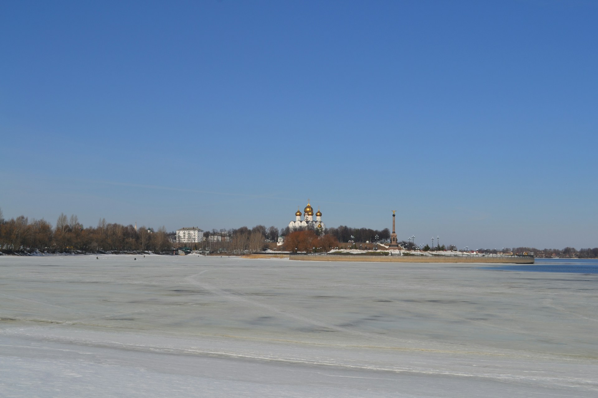 a large body of water with a church in the background