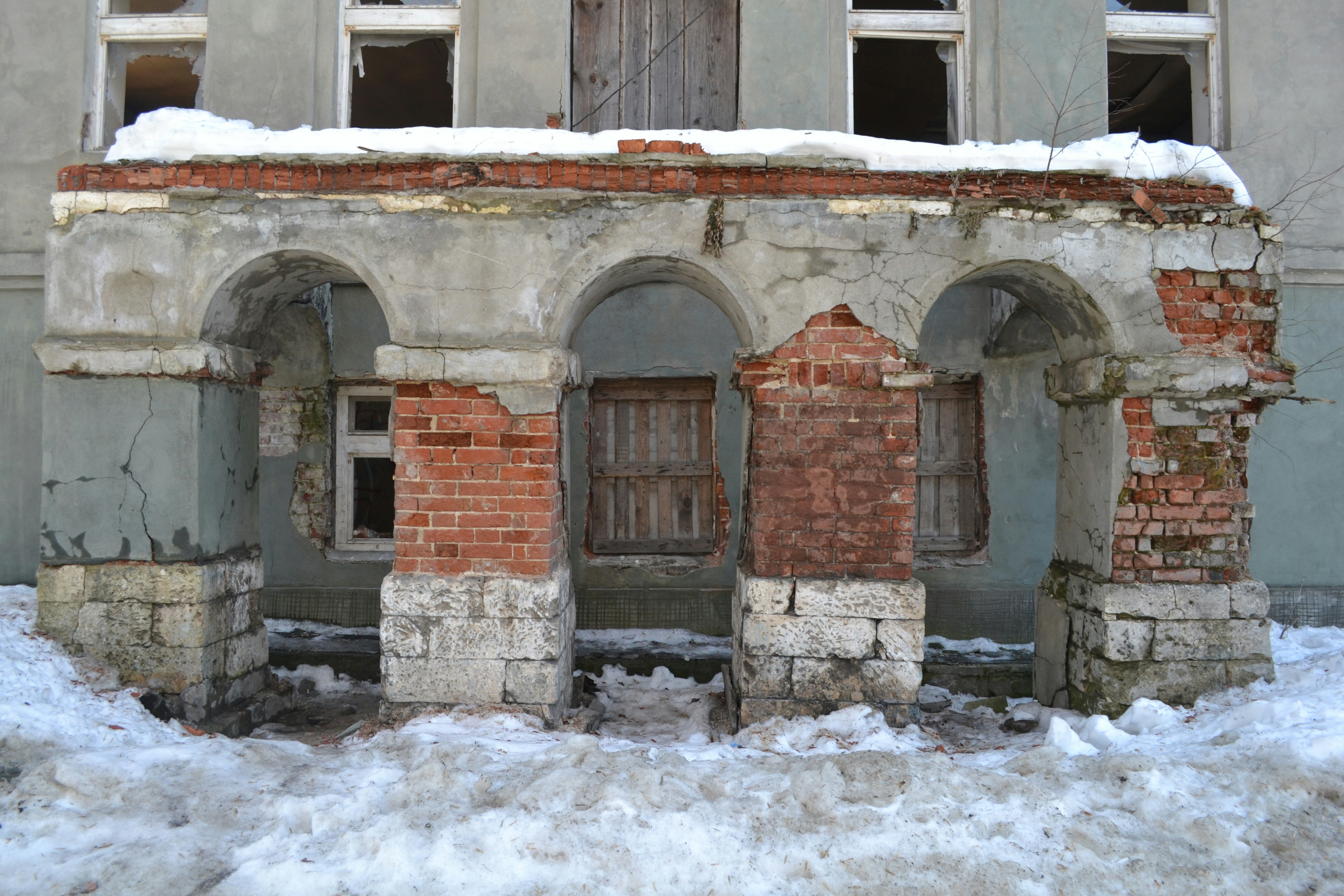 an old building with snow on the ground