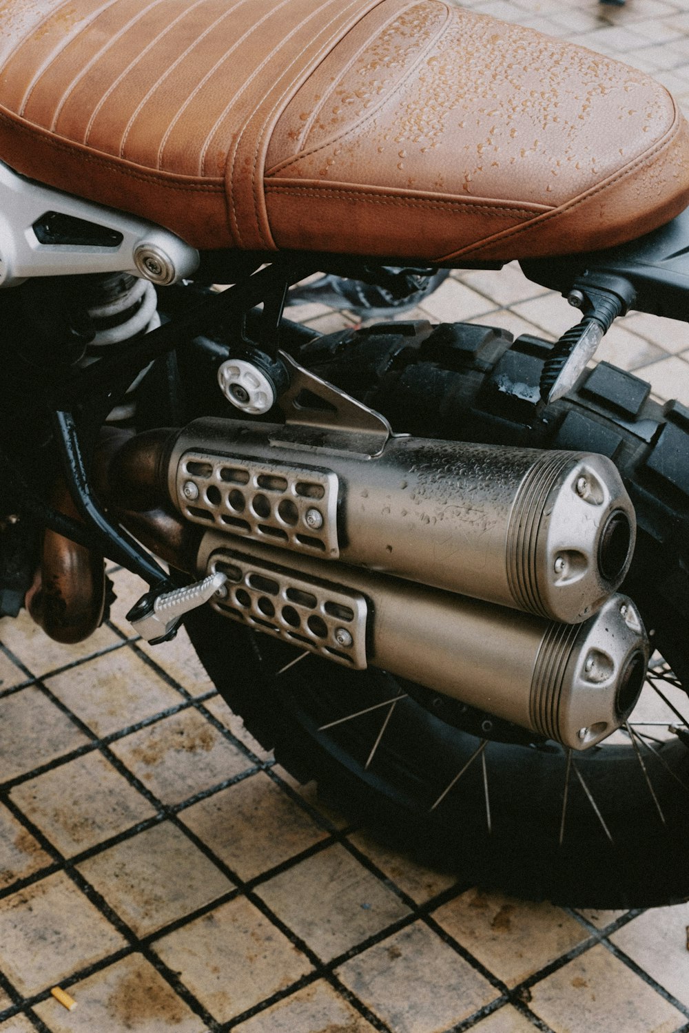 a close up of a motorcycle with a leather seat